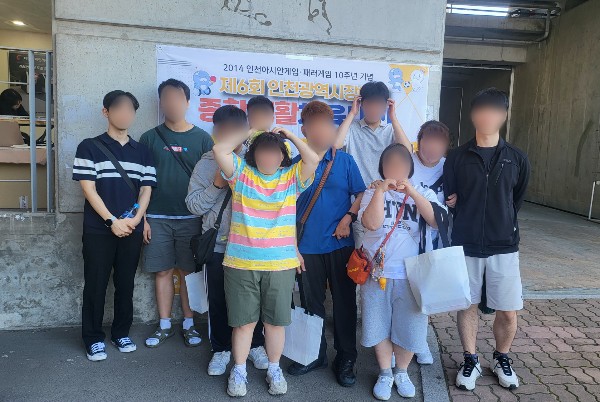 열린일터 이용인들이 강사와 함께 대회장 앞에 모여 기념 촬영을 하는 모습.jpg
